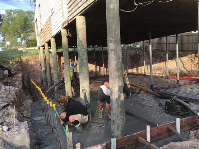 Crew working beneath a house during a restump